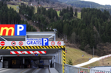 Parking deck and skiing area with artificial snow in the background, Zillertal skiing area, Zillertal valley, Tyrol, Austria