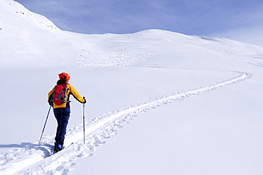 Female backcountry skier ascending to Kreuzeck, Radstaedter Tauern, Niedere Tauern, Salzburg, Austria