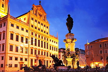 Augustusbrunnen Fountain on Rathausplatz square with illuminated city hall, night shot, Augsburg, Bavaria, Germany