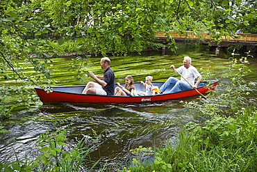 Father, children and grandfather canoeing on the Wuerm River in southern Bavaria, Upper Bavaria, Germany