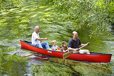 Father, children and grandfather canoeing on the Wuerm River in southern Bavaria, Upper Bavaria, Germany