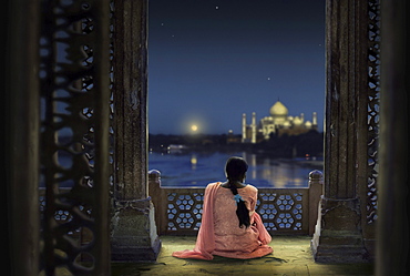 Woman in traditional costume looking at full moon and Taj Mahal, Agra, Uttar Pradesh, India, Asia