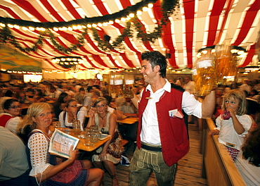 Waiter carrying large beer steins, Gauboden Festival, Straubing, Lower Bavaria, Germany