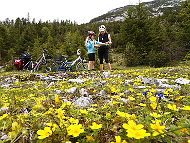 Mother and daughter reading map, Isar Cycle Route, Hinterau Valley, Karwendel range, Tyrol, Austria