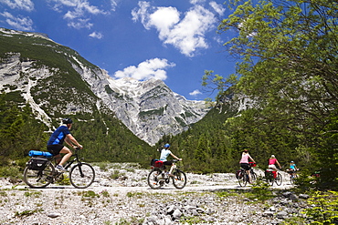 Families cycling along Isar Cycle Route, Hinterau Valley, Karwendel range, Tyrol, Austria