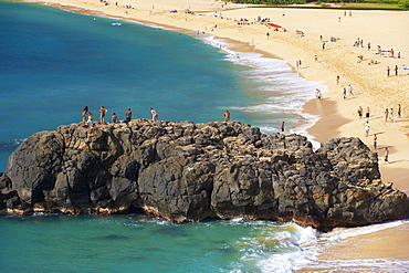 People on a rock at the beach, Weimea Bay Beach Park, North Shore, Oahu, Hawaii, USA, America