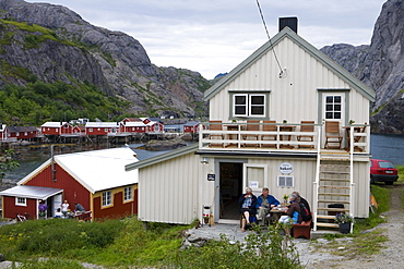 People enjoy Afternoon Coffee outside Bakery, Nusfjord, Flakstadoy, Lofoten, Nordland, Norway, Europe