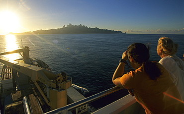 People on the freighter The Aranui III approaching the island of Ua Pou, French Polynesia