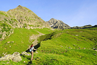 Woman ascending to mount Habicht, Gschnitz valley, Stubai Alps, Tyrol, Austria