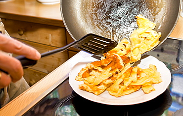 Cook making sugared raisin pancake, Kaiserschmarrn, Molterau alpine hut, Region of Hochkoenig, Salzburger Land, Austria