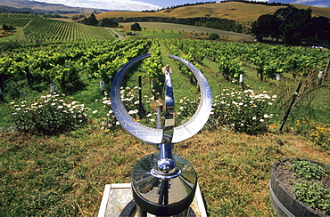 Sundial in front of vineyard in a wine growing district, South Island, New Zealand