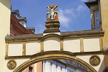 Archway with sculpture of crucification in Liebfrauenstrasse, Trier on Mosel, Rhineland-Palatinate, Germany, Europe