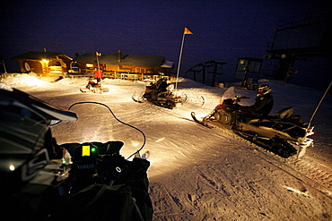 Snowmobiles near mountain lodge Crystal Hut, Blackcomb Mountain, Whistler, British Columbia, Canada