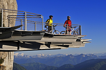 People on mountain bikes on viewing platform at Triassic Park, Reit im Winkl, Bavaria, Germany, Europe