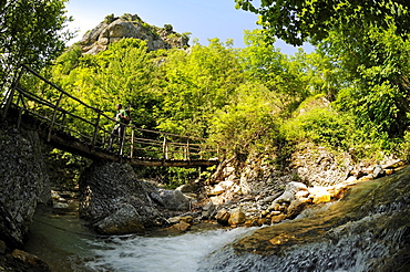 Hiker with on a bridge in the country, Caramanico Terme, Orfento gorge, Maiella National Park, Abruzzi, Italy, Europe