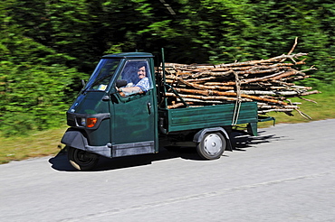 Old woman carrying wood on Vespa APE, Abruzzi, Italy, Europe