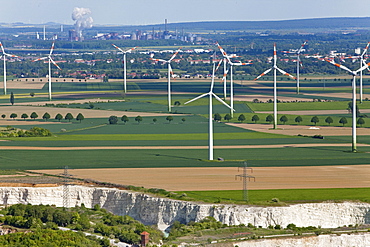 Aerial view of a wind farm, turbines in an agricultural landscape, lime pit in the foreground, steelworks in the background, Salzgitter, Lower Saxony, Germany