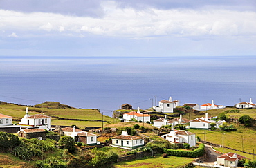 Houses at the south coast under clouded sky, Island of Santa Maria, Azores, Portugal, Europe