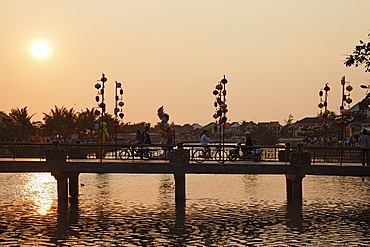 People passing bridge in the evening, Hoi An, Annam, Vietnam