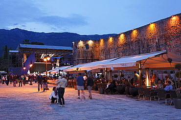 Restaurants along the city wall in the evening, Budva, Montenegro, Europe