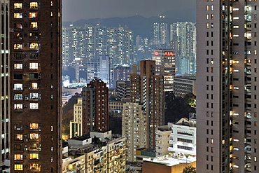 Hong Kong housing estate and American International Assurance Centre at night, Hong Kong, China