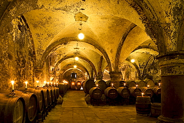 Candlelit barrels inside wine cellar of Eberbach abbey, a medieval monastery at Eltville am Rhein, Rheingau, Hesse, Germany, Europe