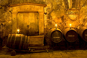 Candlelit barrels inside wine cellar of Eberbach abbey, a medieval monastery at Eltville am Rhein, Rheingau, Hesse, Germany, Europe