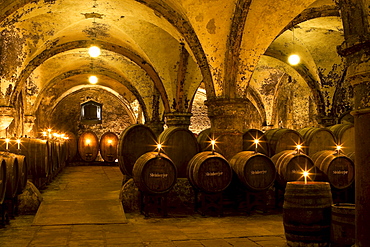 Candlelit barrels inside wine cellar of Eberbach abbey, a medieval monastery at Eltville am Rhein, Rheingau, Hesse, Germany, Europe