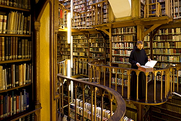 Monk at the library at Maria Laach abbey, Eifel, Rhineland-Palatinate, Germany, Europe