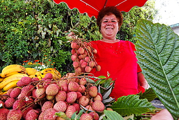 Local woman selling lychees at a stall, La Plaine des Palmistes, La Reunion, Indian Ocean