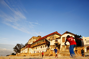 Children playing soccer on the beach of Stonetown, Zanzibar City, Zanzibar, Tanzania, Africa