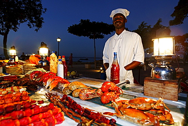 Monger at a stand, night market at Forodhani Gardens, Stonetown, Zanzibar City, Zanzibar, Tanzania, Africa