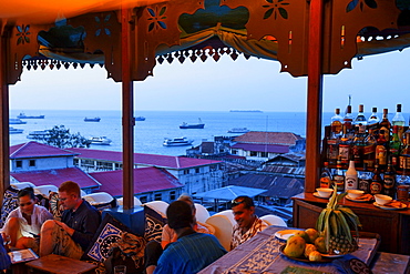 People on the roof terrace of the Hurumzi hotel in the evening, Stonetown, Zanzibar City, Zanzibar, Tanzania, Africa