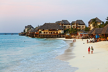 People on the beach and the Z hotel at dusk, Nungwi, Zanzibar, Tanzania, Africa