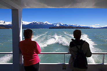 Two women on board a ship on the passage to the glaciers at Lago Argentino, Los Glaciares National Park, near El Calafate, Patagonia, Argentina