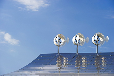 Small wind turbines and solar installations on the roof of Hotel Victoria, Freiburg im Breisgau, Baden-Wuerttemberg, Germany, Europe