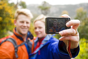 Two hikers taking a photograph of themselves near Little Oberon Bay, Wilsons Promontory National Park, Victoria, Australia