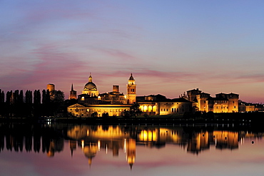 Illuminated old town of Mantua reflecting in river of Mincio, Mantua, Lombardy, Italy, Europe