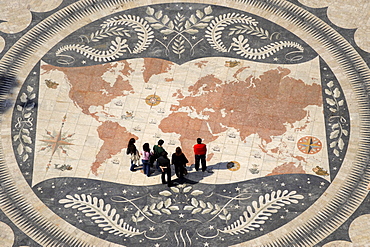 People looking at world map on the ground in front of Monument of the Discoveries, Lisbon, Portugal, Europe