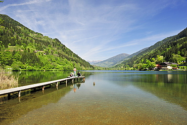 Anglers standing on landing stage in lake Afritzer See, lake Afritzer See, Carinthia, Austria, Europe