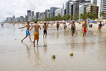 Boys playing beach soccer with coconut goal posts, Recife, Pernambuco, Brazil, South America