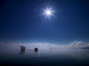 View from Krautinsel towards the cloud-covered Alps, Lake Chiemsee, Chiemgau, Bavaria, Germany