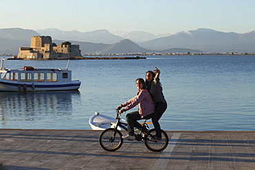 two young girls on bike, Nauplia, Peloponnes, Greece