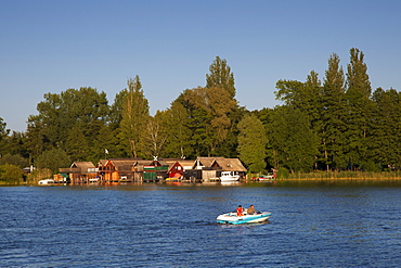 Boathouses and motorboat, at Schwerin lake, Schwerin, Mecklenburg Western-Pomerania, Germany