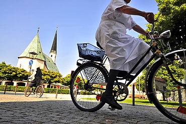 Cyclists at suqare Kapellplatz, Altoetting, Bavaria, Germany, Europe