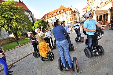 People on segways during a guided tour at the old town of Bratislava, Slovakia, Europe