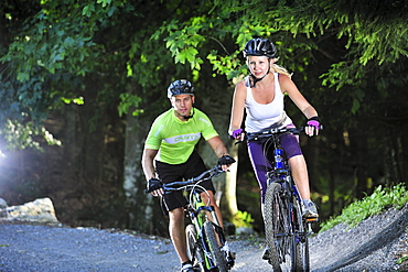 Two mountain bikers in a bike park, Hochries, Samerberg, Upper Bavaria, Germany