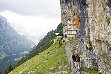 Mountain hikers near mountain inn Aescher, Ebenalp, Alpstein massif, Appenzell Innerrhoden, Switzerland