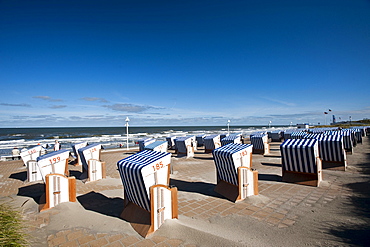 Roofed wicker beach chairs at promenade, Norderney, East Frisian Islands, Lower Saxony, Germany