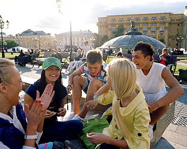 Teenage friends meeting up at Manege square, Moscow, Russia, Europe